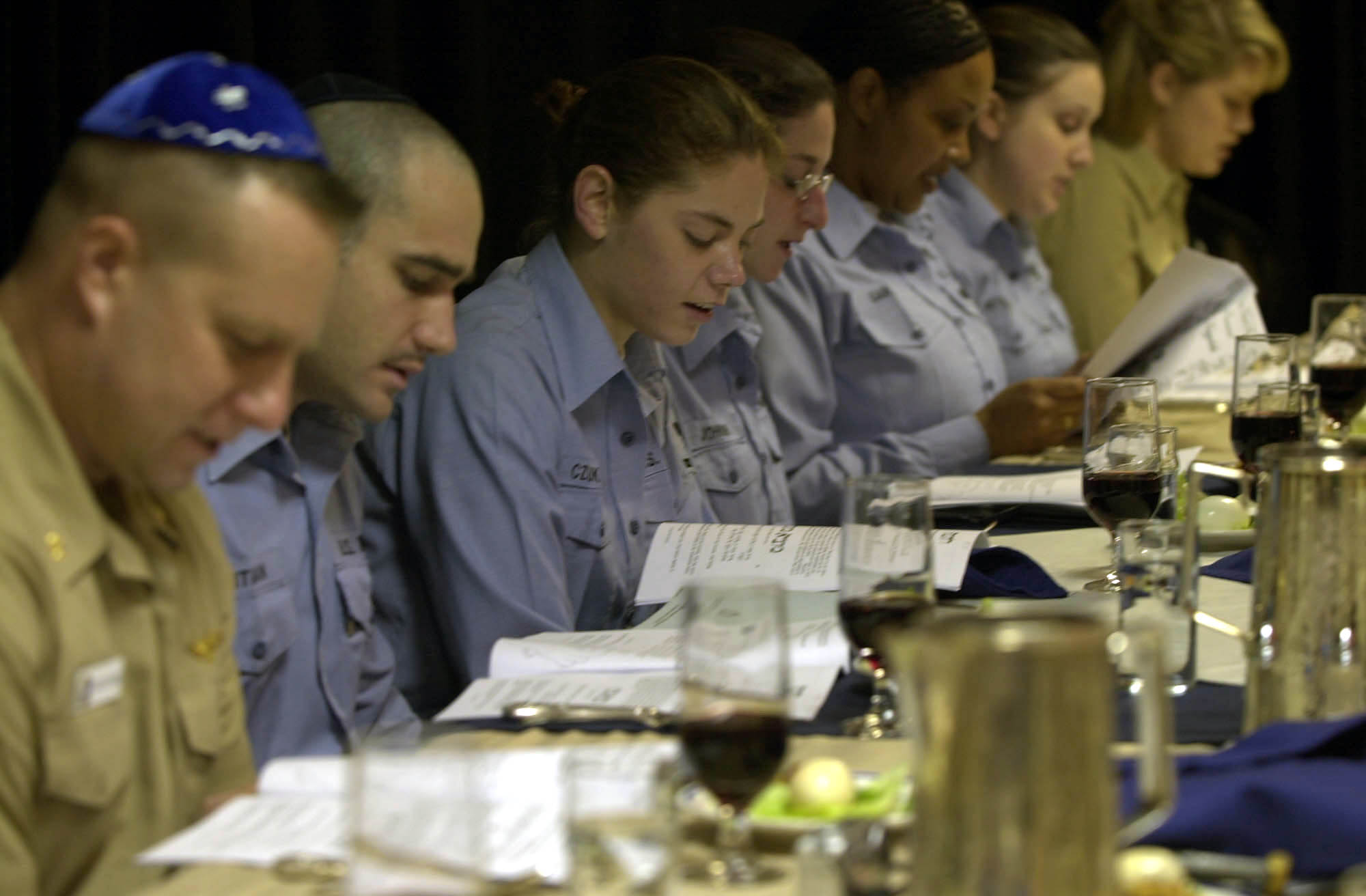 US Navy Crewmembers read from the Passover Hagaddah during the Passover