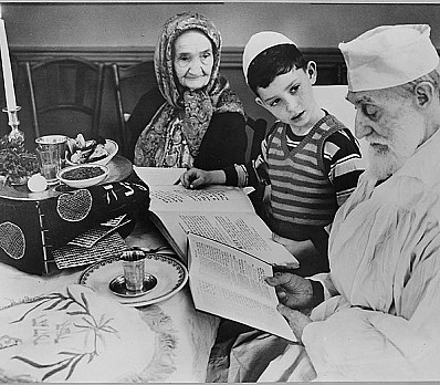 Photograph of a Young Jewish Boy with Elders at a Passover Ceremony, 04/16/1951